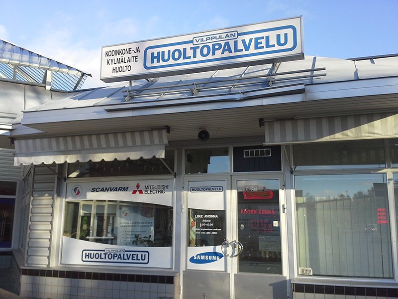 Liikerakennuksen julkisivu, jossa on sininen HUOLTOPALVELU-kyltti